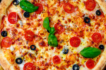 Delicious italian pizza served on table with ingredients cheese and vegetables