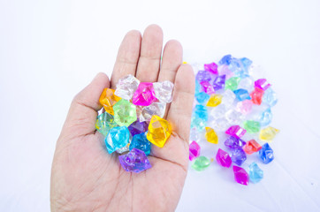 Beautiful colored marble in hand on white background