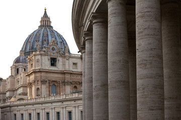 Papal Basilica of St. Peter in the Vatican and columns on Saint Peter`s square in Vatican.