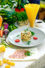Italian pasta carbonara served on a table with ingredients
