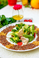 salad with red quinoa and chicken breast with tomatoes served on the table with ingredients, healthy food