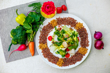 salad with red quinoa and chicken breast with tomatoes served on the table with ingredients, healthy food