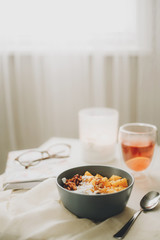 healthy breakfast cereal with candle and glasses in the background
