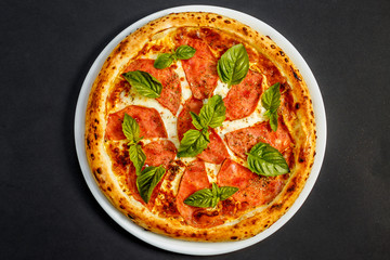 hot italian pizza with cheese and basil, isolated