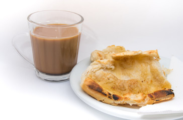 Popular brazilian bread with melted butter called pao na chapa. Pao na chapa traditional brazilian breakfast. Glass of hot coffee with milk called pingado. 