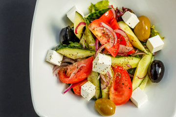 fresh greek salad with tomatoes, feta cheese, onions, olives and cucumbers, healthy food, isolated