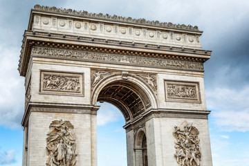 Fototapeta na wymiar Arc de Triomphe in Paris against the backdrop of a beautiful bright blue sky. Close-up.
