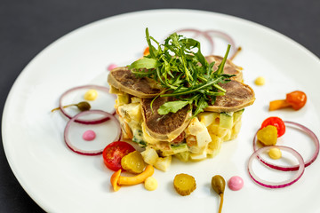 salad with meat and ingredients on a white plate