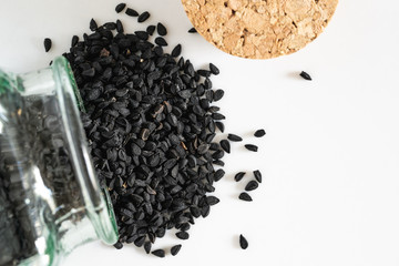 Nigella sativa seeds spread from jar to table