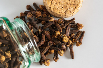 Cloves spread from jar to table