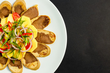 Kazakh cuisine, meat with boiled potatoes onions and herbs, on a white plate