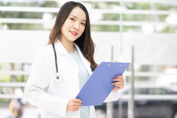 Fototapeta na wymiar A woman doctor hold the document in hospital
