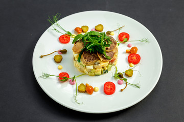 salad with meat and ingredients on a white plate