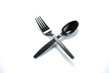 black plastic spoon and fork isolated on white background