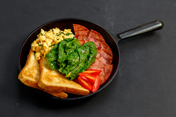 delicious omelet with bacon greens and toast in a pan, breakfast