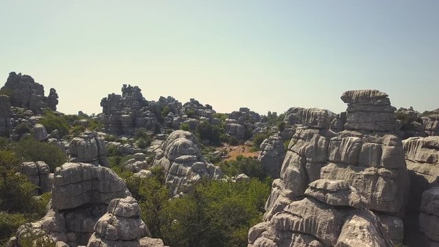 Cinematic aerial view of "El Torcal" mountain in Antequera. Drone flying close to the rocks. This rocks had their origin in the seabed during the Jurassic period, between 250 and 150 million years ago