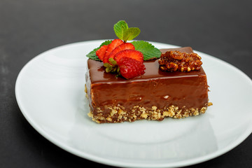 a slice of delicious chocolate cake with nuts and berries