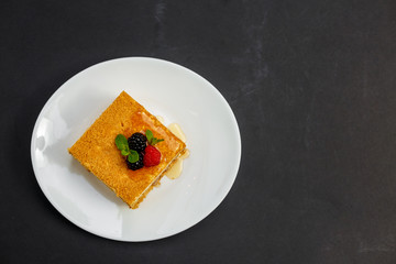 a slice of honey cake with berries, sweet dessert