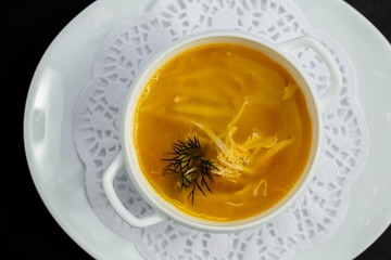 hot noodle soup with chicken and broth on a white plate