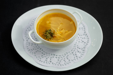 hot noodle soup with chicken and broth on a white plate