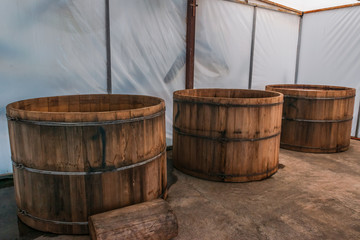 Full shot of three mezcal barrels