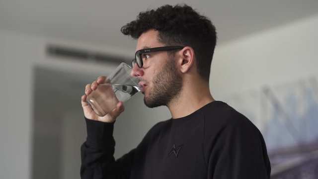 Caucasian man drinking a glass of water
