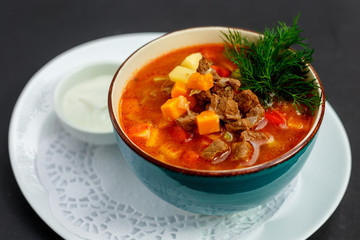 hot soup with broth and stew with vegetables