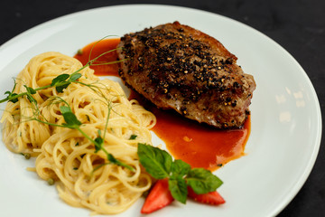 juicy cutlet with pepper and Italian spaghetti with sauce