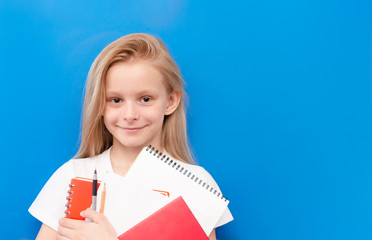 Little girl in  surgical medical mask isolated on blue background. Virus protection concept. Top horizontal view