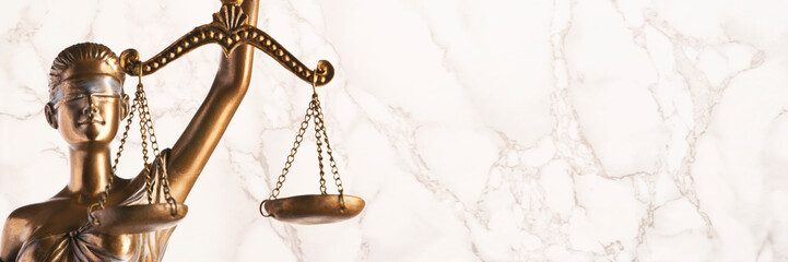 Bronze Themis statue - symbol of Justice - with a marble background