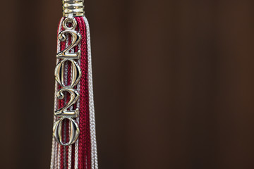 2020 Graduation Tassel on a dark wooden background