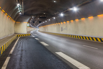 Urban underground tunnel with few cars in early morning.  