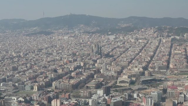 AERIAL: Barcelona Wide Drone Shot of City Towards Center with La Sagrada Familia and Torre Glories, Torre Agbar 