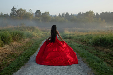 woman in red dress walking on the road
lonely thinking of the future
