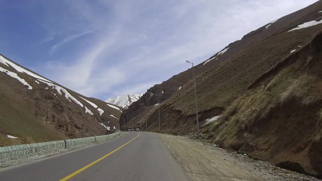 CHALUS, IRAN: Dolly Tracking Pov Front Shot View Of Driving In a mountainous Country Road with traffic