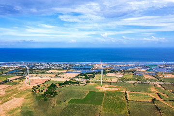 Fototapeta na wymiar Aerial view of wind turbines beside sea and coastal road Cam Ranh - Mui Dinh - Ca Na on a sunny day, Phuoc Dinh, Phan Rang, Ninh Thuan, Vietnam. Mui Dinh lighthouse 3 km away from here