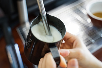 Steam milk for Latte art coffee at cafe