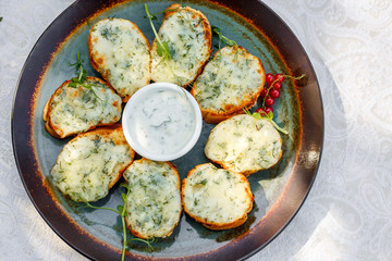 garlic bread with raw greens and sauce on a decorated table