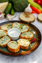 garlic bread with raw greens and sauce on a decorated table