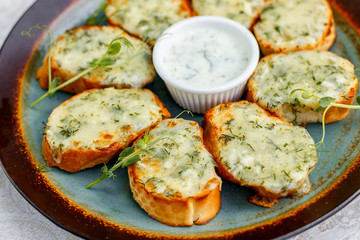 garlic bread with raw greens and sauce on a decorated table