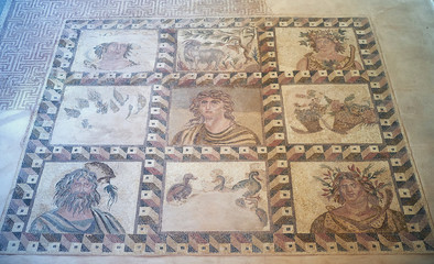 Fototapeta na wymiar Four Seasons mosaic on the floor on the villa Dionysos. Paphos Archaeological Park. Cyprus