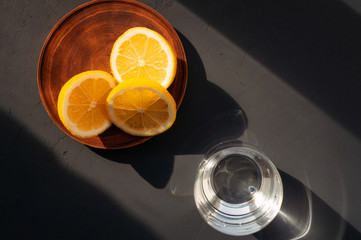 Glass of pure water and lemon, top view