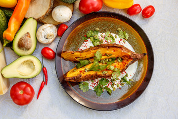 Baked Zucchini with greens and vegetables, healthy food on a decorated table