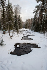 already slightly thawed, the river sheds its ice shackles after winter in the Taganay national Park