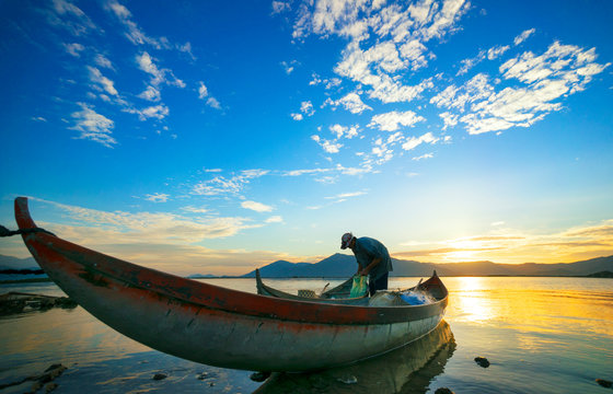 Traditional Boat and location fisherman on the beach at sunrise time, Hon Thien village, Phan Rang, Vietnam