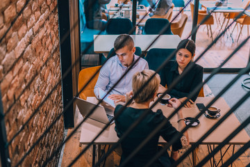 Business meeting inside a cafe with the focus through a fence.