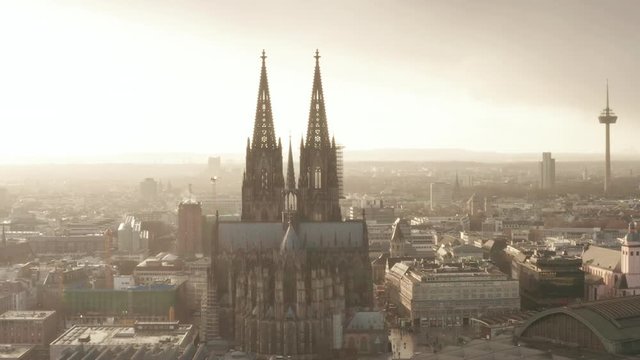AERIAL: Towards Cologne Cathedral and TV Tower in beautiful hazy Sunlight with Rain 