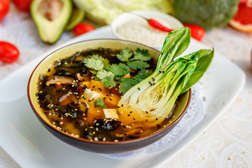 Thai soup tom yam with seafood and cheese on decorated table