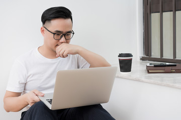 Home office scene of young Asian men