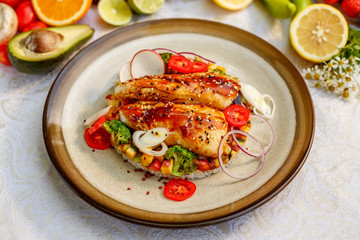 Fish fillet with sesame rice, and vegetables, healthy food on a decorated table